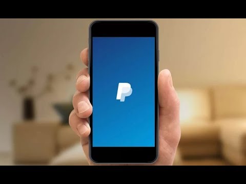 person holding smartphone with paypal business app