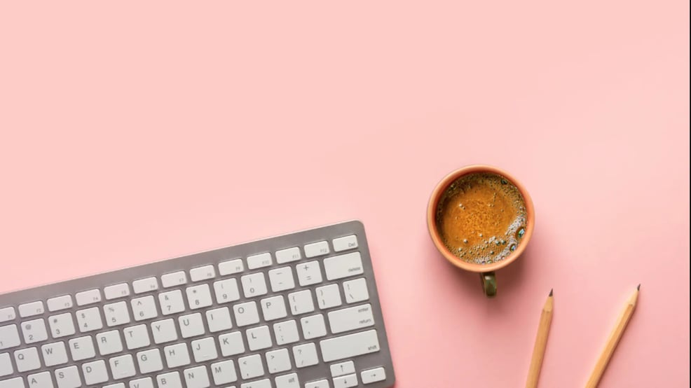 Keyboard and coffee mug on a desk