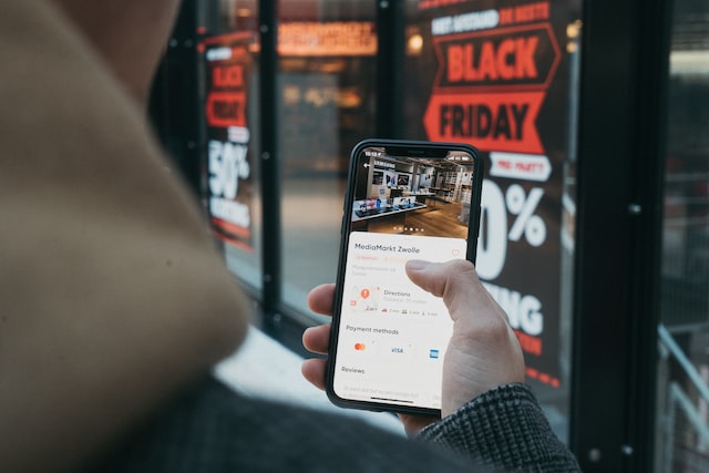 person using smartphone to shop Black Friday deals