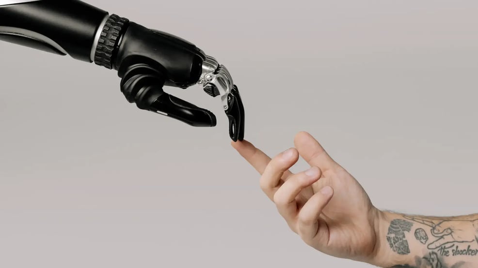 bionic-hand-and-human-hand-finger-pointing-blog-banner