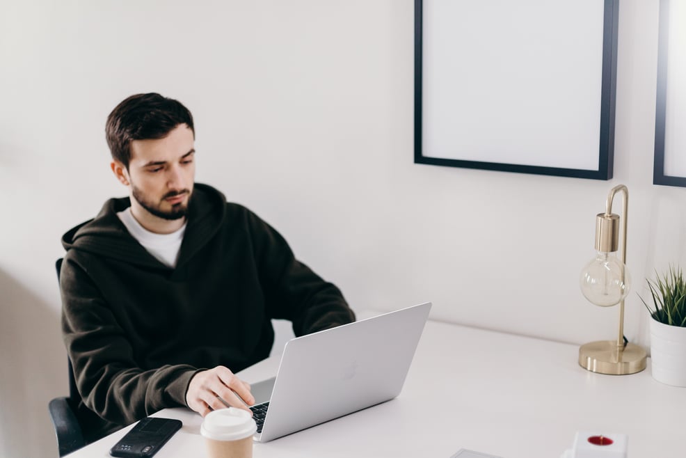 man-in-black-sweater-using-laptop