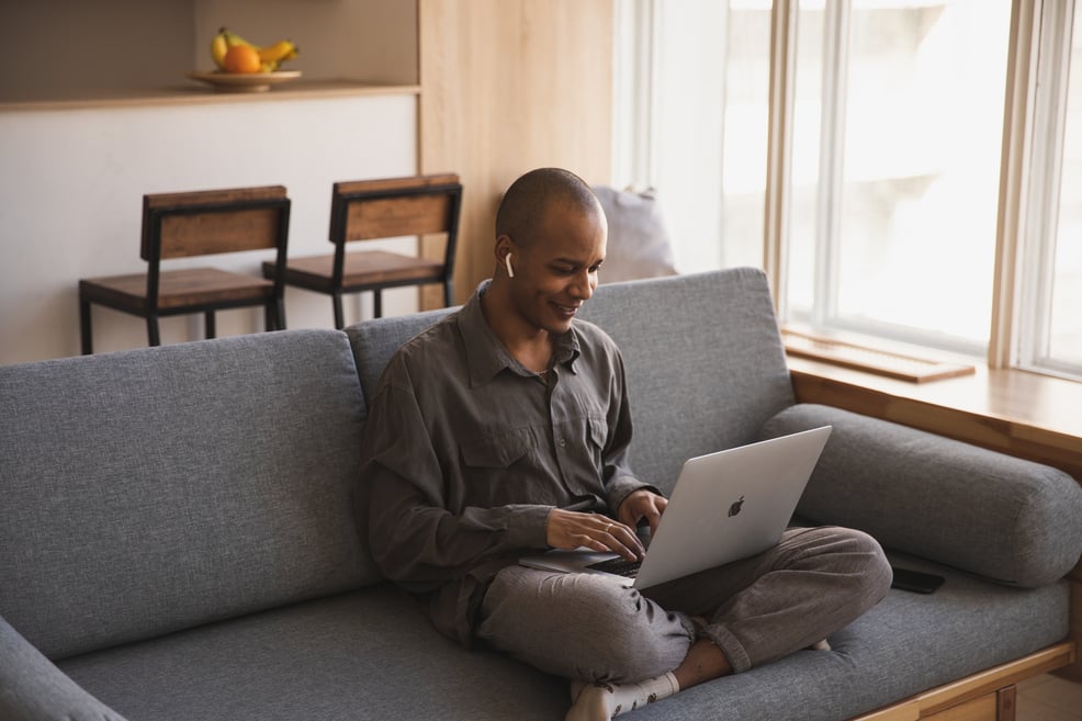 man-sitting-on-the-couch-using-laptop