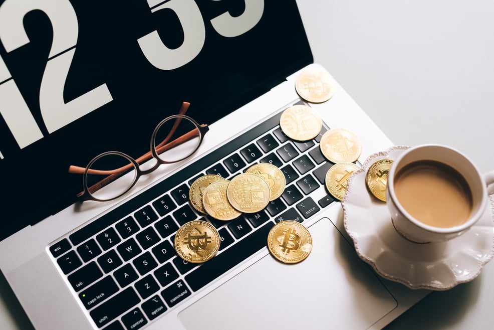 gold-coins-and-cup-of-coffee-on-laptop