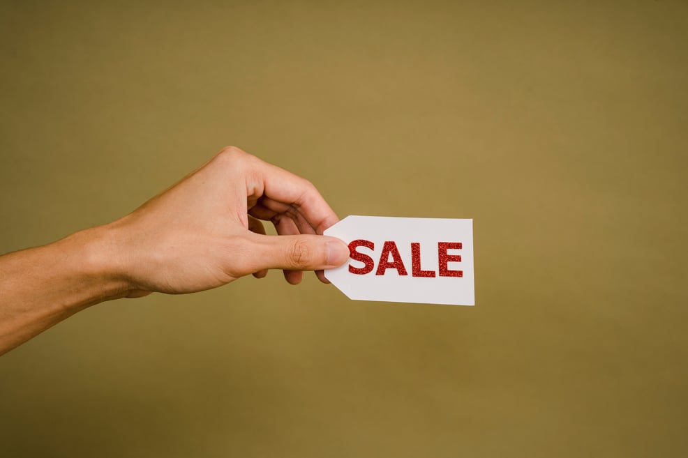 hand-holding-sale-sign